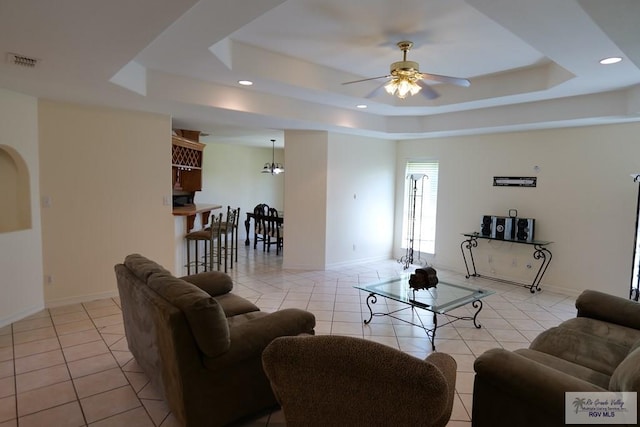 9165 Los Olmos Dr, Los Fresnos, TX 78566 - living area featuring light tile patterned flooring, a tray ceiling, a ceiling fan, recessed lighting, and baseboards
