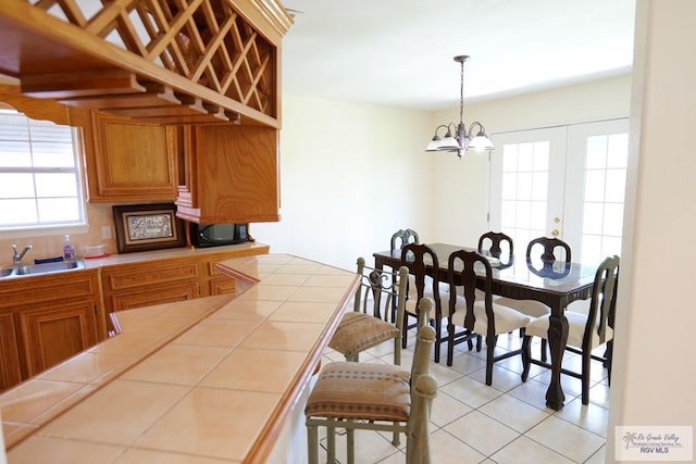 9165 Los Olmos Dr, Los Fresnos, TX 78566 - dining space featuring light tile patterned flooring and a chandelier