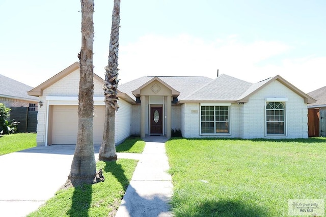9165 Los Olmos Dr, Los Fresnos, TX 78566 - ranch-style house featuring driveway, an attached garage, and a front yard