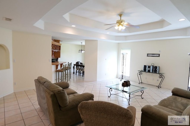9165 Los Olmos Dr, Los Fresnos, TX 78566 - living room featuring light tile patterned floors, a tray ceiling, ceiling fan, recessed lighting, and baseboards