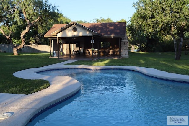 view of pool featuring a lawn