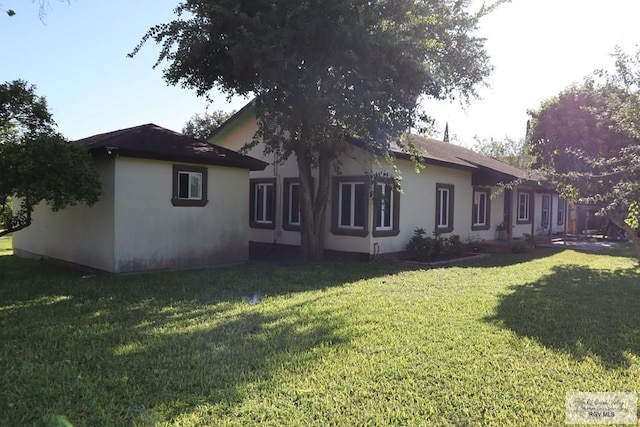 view of home's exterior with a yard