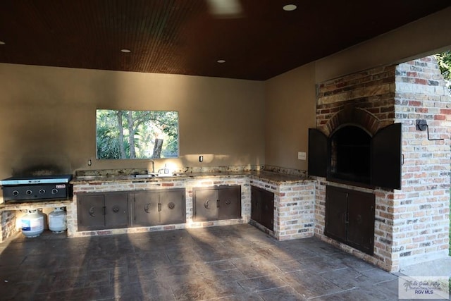 view of patio / terrace featuring area for grilling, sink, and an outdoor kitchen