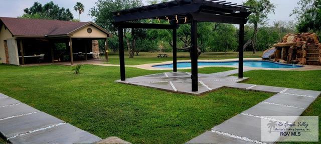 surrounding community with a lawn, a pergola, a patio, and a swimming pool