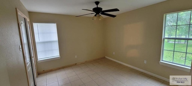 tiled spare room with ceiling fan