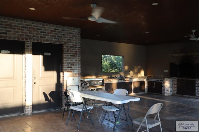 view of patio featuring an outdoor kitchen and ceiling fan