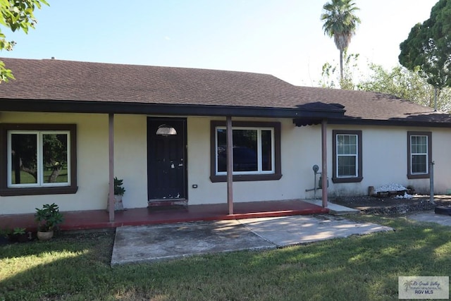 single story home with a porch and a front yard