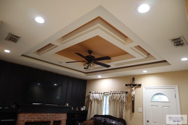 interior space featuring ceiling fan and a raised ceiling