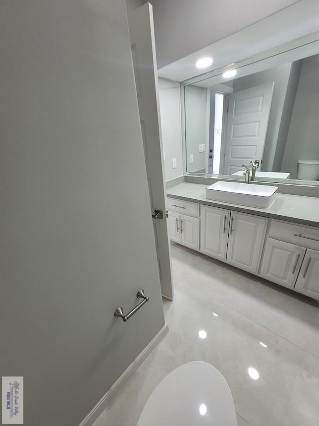 bathroom featuring toilet and vanity
