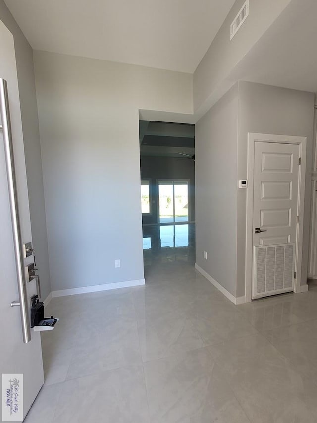 empty room featuring visible vents and baseboards