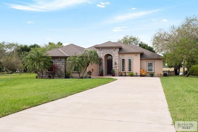 view of front facade with a garage and a front lawn