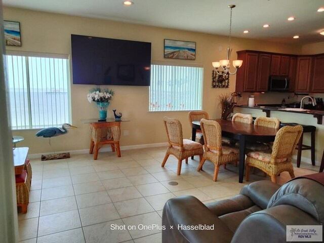 301 E Houston St Unit 1201, Port Isabel, TX 75052 - dining area featuring an inviting chandelier, light tile patterned floors, baseboards, and recessed lighting