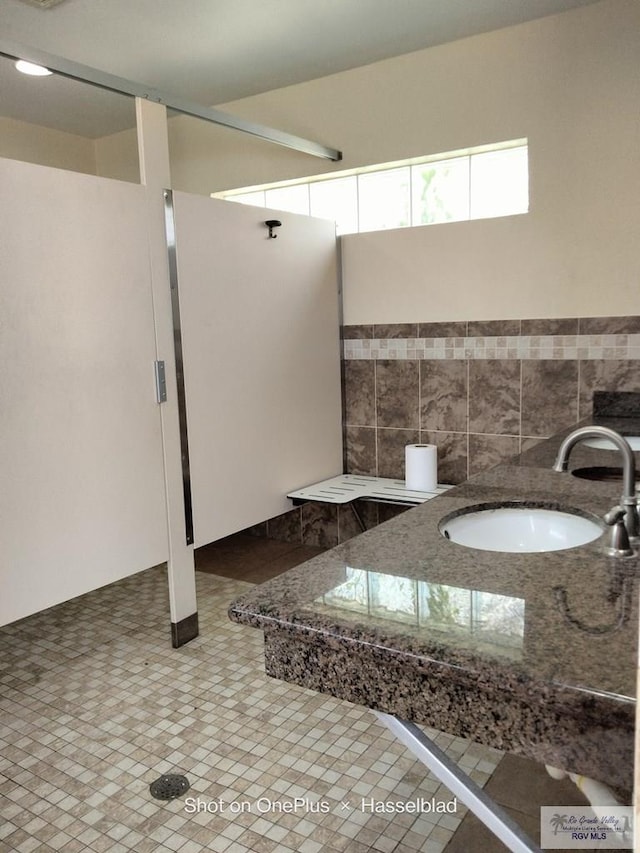 bathroom featuring tile patterned floors and a sink