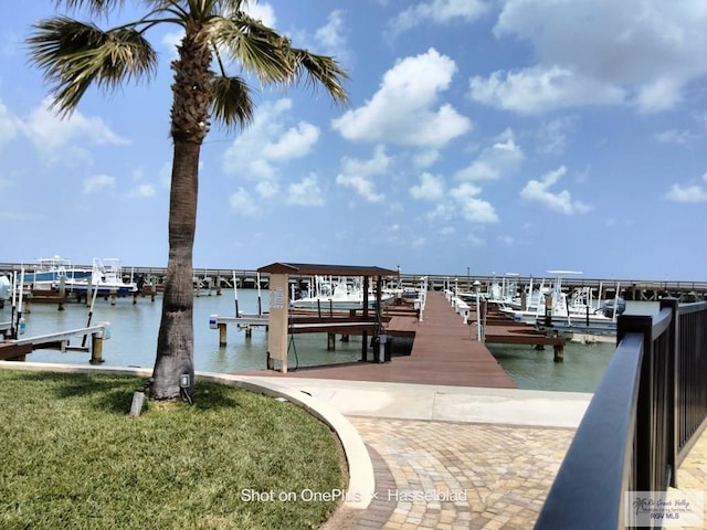 dock area with boat lift and a water view