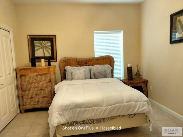 bedroom with tile patterned flooring and baseboards