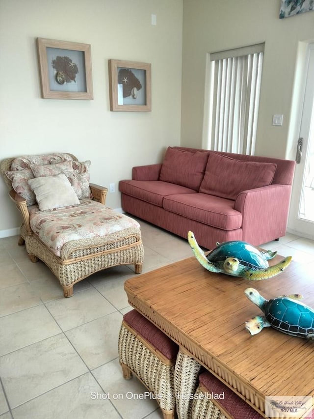 living room with baseboards and tile patterned flooring