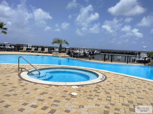 301 E Houston St Unit 1201, Port Isabel, TX 75052 - community pool with fence, a patio, and a hot tub