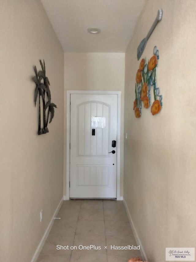 301 E Houston St Unit 1201, Port Isabel, TX 75052 - doorway featuring light tile patterned flooring and baseboards