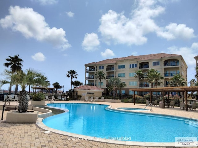 301 E Houston St Unit 1201, Port Isabel, TX 75052 - community pool with fence, a patio, and a hot tub
