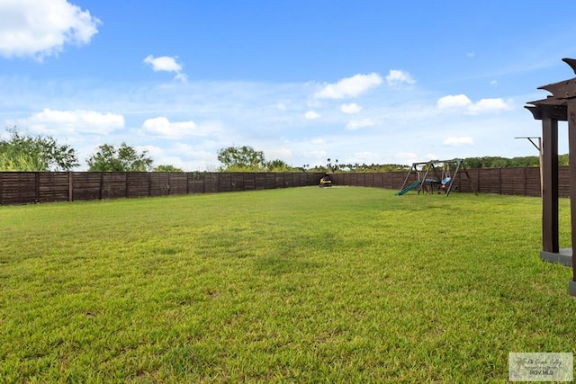 31689 E Jardin E, Los Fresnos, TX 78566 - fenced backyard with a playground
