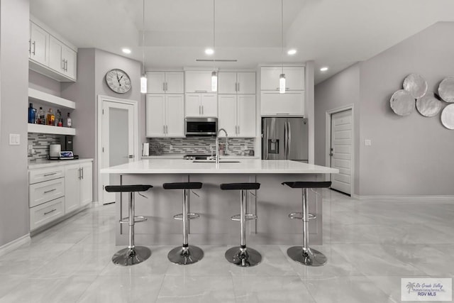 31689 E Jardin E, Los Fresnos, TX 78566 - kitchen featuring stainless steel appliances, recessed lighting, backsplash, white cabinets, and light countertops