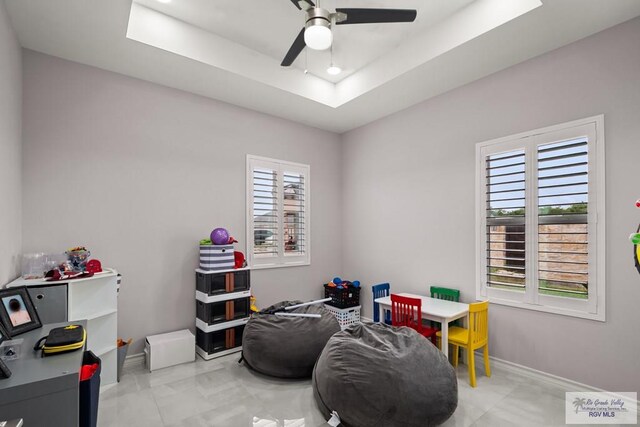 31689 E Jardin E, Los Fresnos, TX 78566 - recreation room featuring ceiling fan, a raised ceiling, and marble finish floors