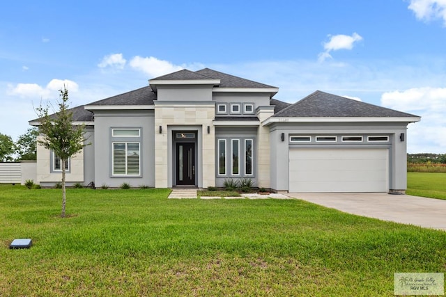 31689 E Jardin E, Los Fresnos, TX 78566 - prairie-style house with an attached garage, driveway, a front yard, a shingled roof, and stucco siding