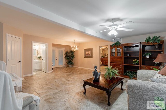 living room with ceiling fan with notable chandelier