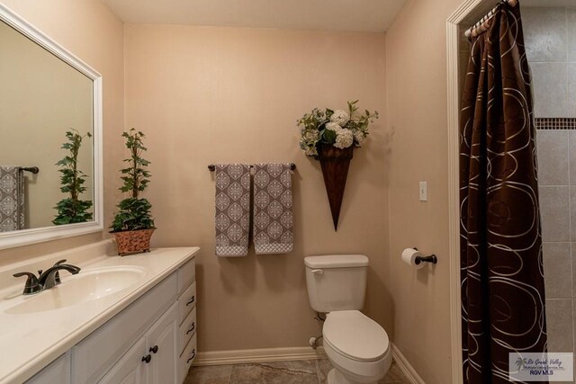 bathroom with tile patterned floors, vanity, and toilet