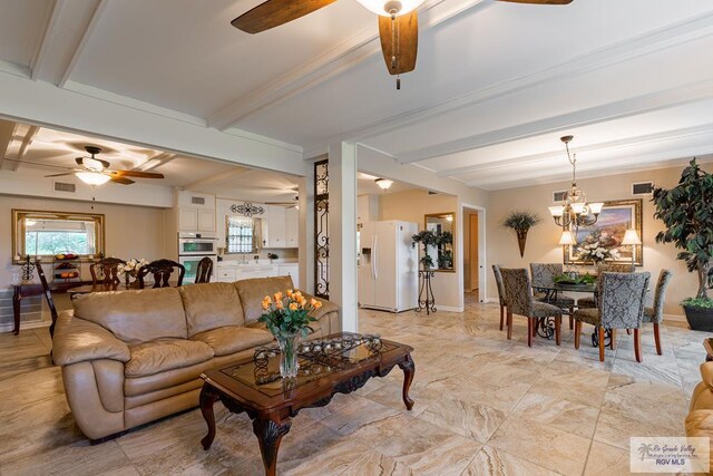 living room featuring beam ceiling, sink, and ceiling fan with notable chandelier