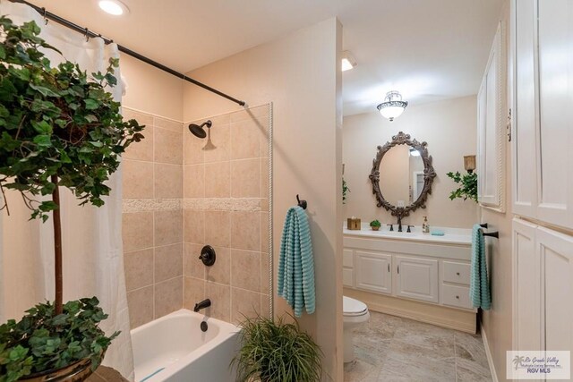 full bathroom with shower / bath combination with curtain, toilet, and vanity