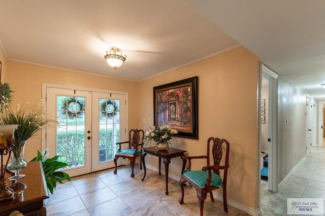 tiled entryway with french doors and crown molding