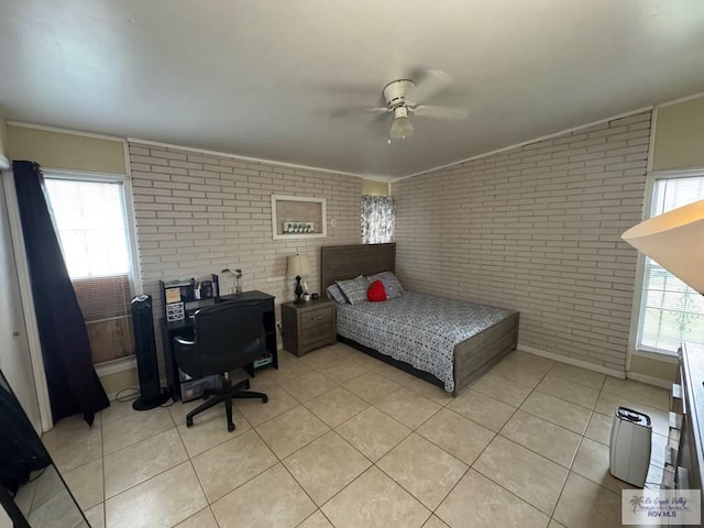 1901 Martha St, Harlingen, TX 78550 - bedroom featuring brick wall, light tile patterned flooring, ornamental molding, and ceiling fan