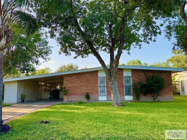 1901 Martha St, Harlingen, TX 78550 - view of front of property featuring driveway, a front yard, an attached carport, and brick siding