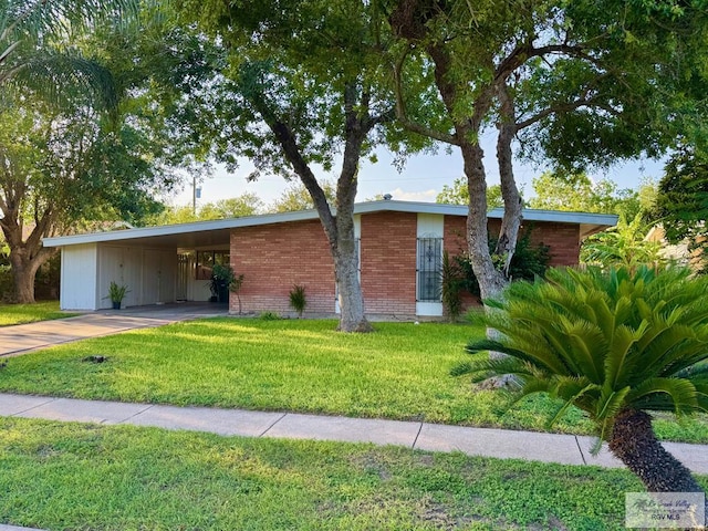 1901 Martha St, Harlingen, TX 78550 - mid-century inspired home with driveway, a front yard, and a carport