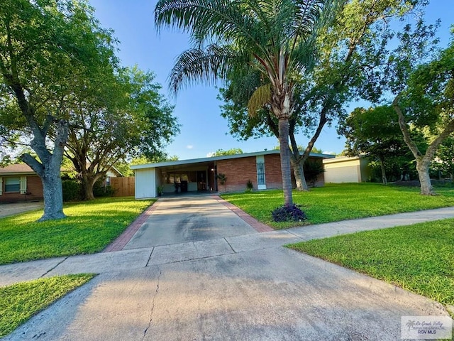 1901 Martha St, Harlingen, TX 78550 - ranch-style house with driveway and an attached carport
