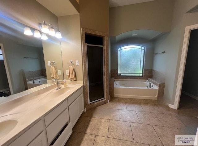 1714 Christian Cir, Harlingen, TX 78550 - bathroom with a garden tub, double vanity, a stall shower, and tile patterned flooring