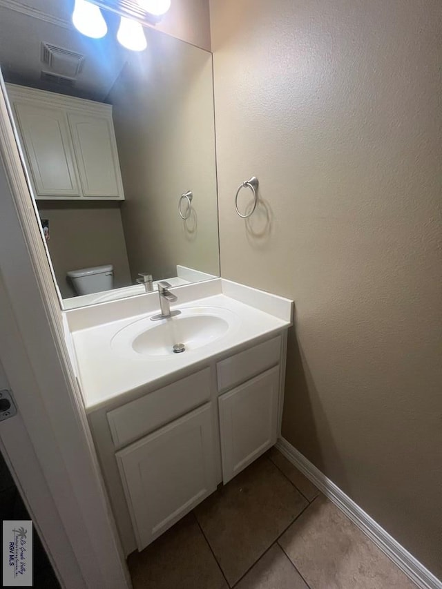 1714 Christian Cir, Harlingen, TX 78550 - bathroom with tile patterned flooring, vanity, baseboards, and toilet