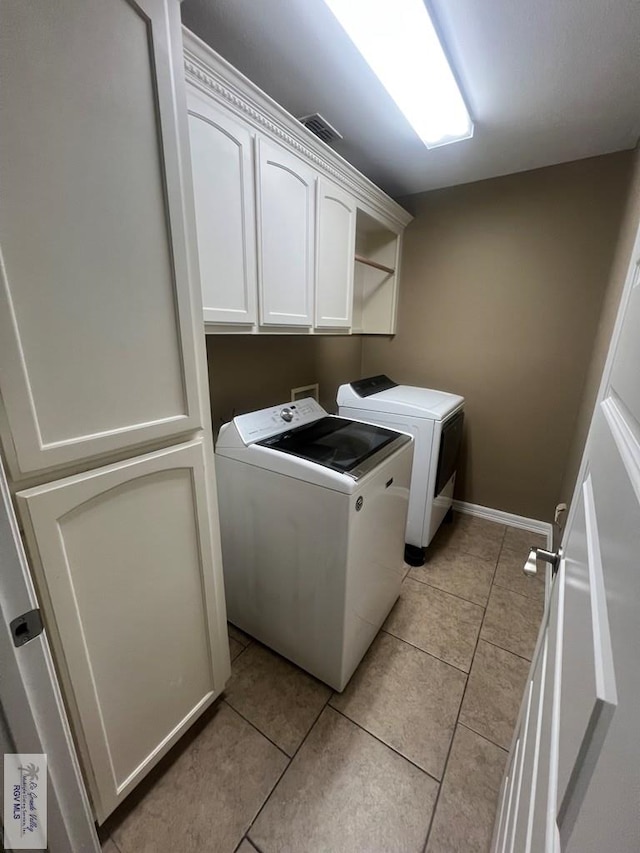 1714 Christian Cir, Harlingen, TX 78550 - laundry room with washing machine and dryer, cabinet space, light tile patterned floors, and baseboards