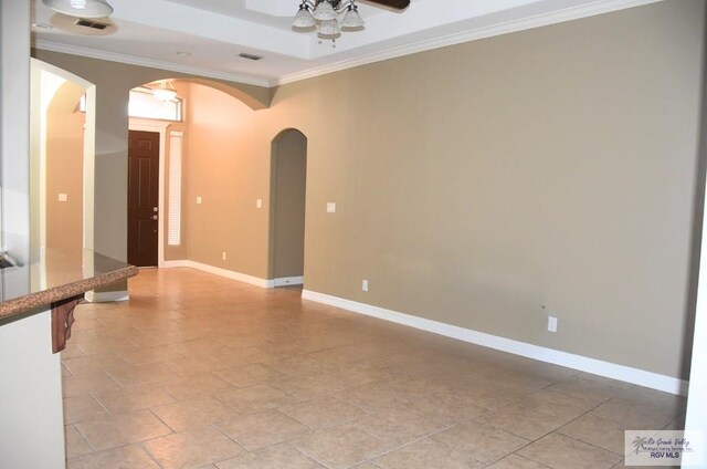 1714 Christian Cir, Harlingen, TX 78550 - spare room featuring arched walkways, ceiling fan, ornamental molding, and baseboards