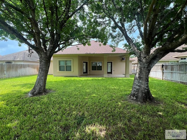 1714 Christian Cir, Harlingen, TX 78550 - rear view of house with stucco siding and a patio