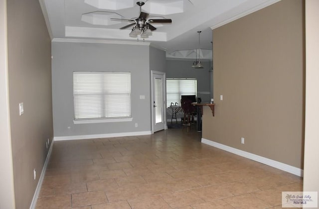 1714 Christian Cir, Harlingen, TX 78550 - unfurnished living room with crown molding, ceiling fan, baseboards, a raised ceiling, and tile patterned floors