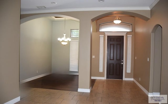 1714 Christian Cir, Harlingen, TX 78550 - entrance foyer with arched walkways, a chandelier, crown molding, and baseboards