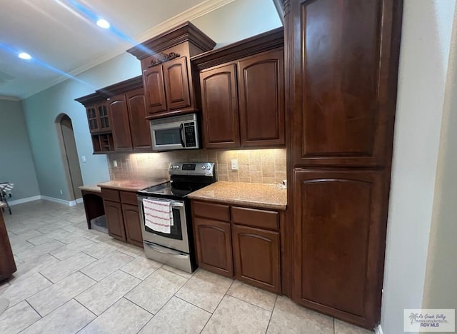 1714 Christian Cir, Harlingen, TX 78550 - kitchen with appliances with stainless steel finishes, ornamental molding, arched walkways, decorative backsplash, and dark brown cabinets