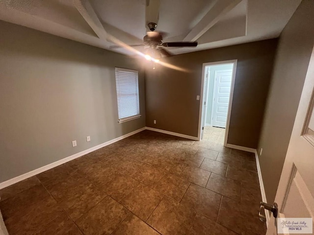 1714 Christian Cir, Harlingen, TX 78550 - spare room featuring a raised ceiling, a ceiling fan, baseboards, and dark tile patterned flooring