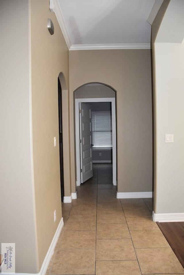 1714 Christian Cir, Harlingen, TX 78550 - hallway with ornamental molding, baseboards, arched walkways, and tile patterned flooring