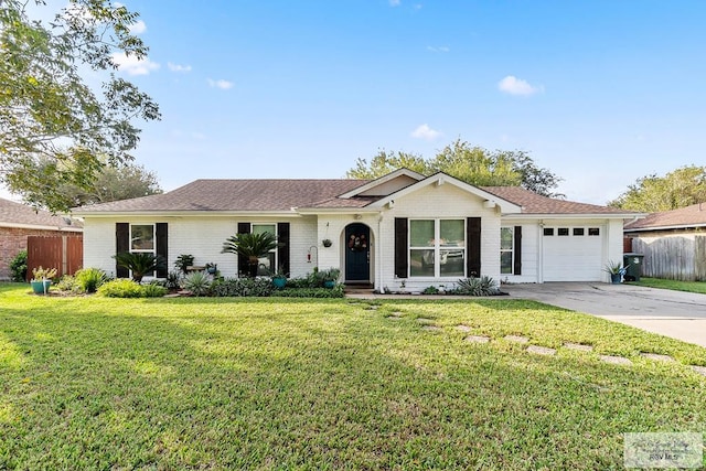 ranch-style home featuring a garage and a front lawn