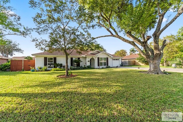 single story home with a front yard and a garage