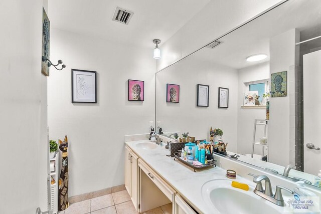 bathroom featuring tile patterned flooring and vanity