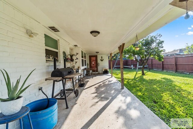 view of patio featuring a grill